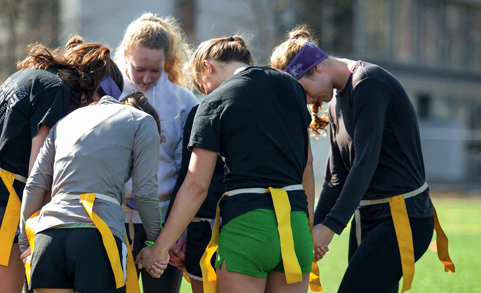 A prayer circle before an intramural match